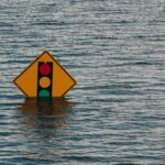 traffic signal road sign partially under flood water