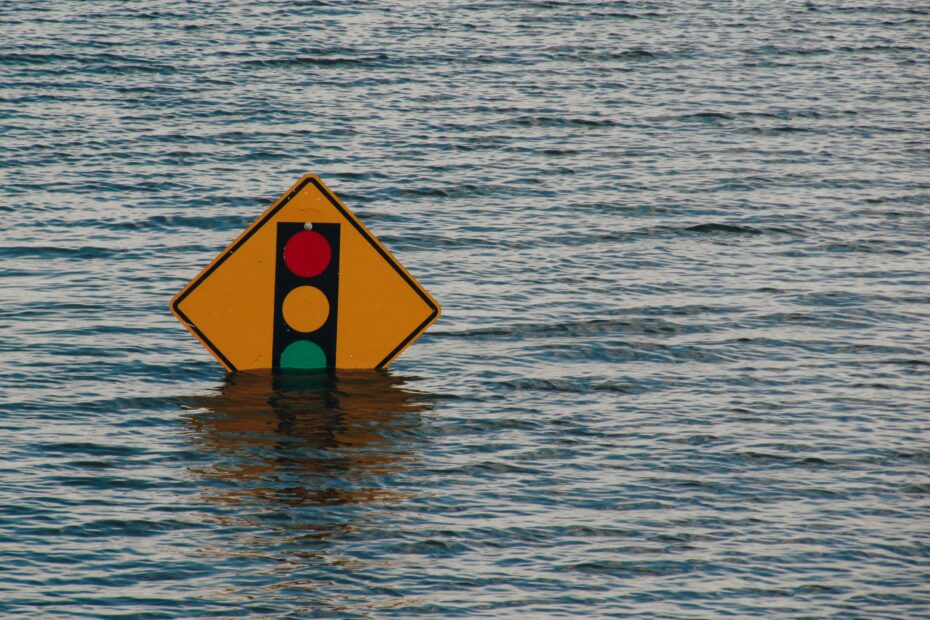 traffic signal road sign partially under flood water